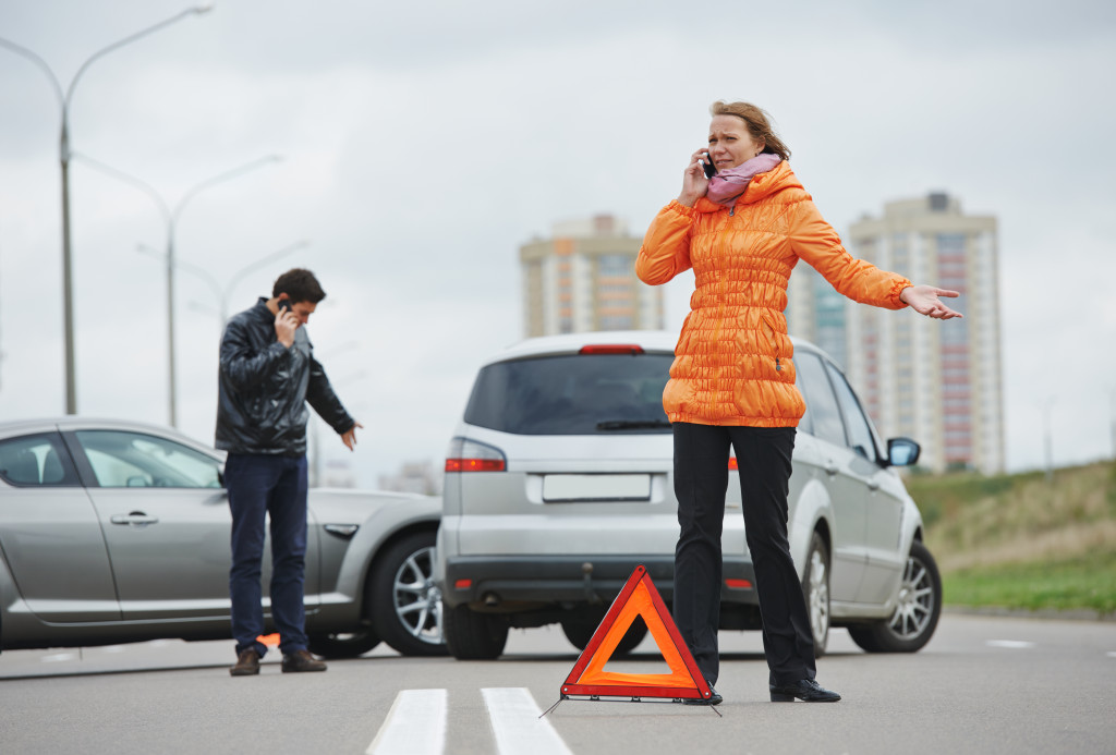 woman calling on the phone after a car accident