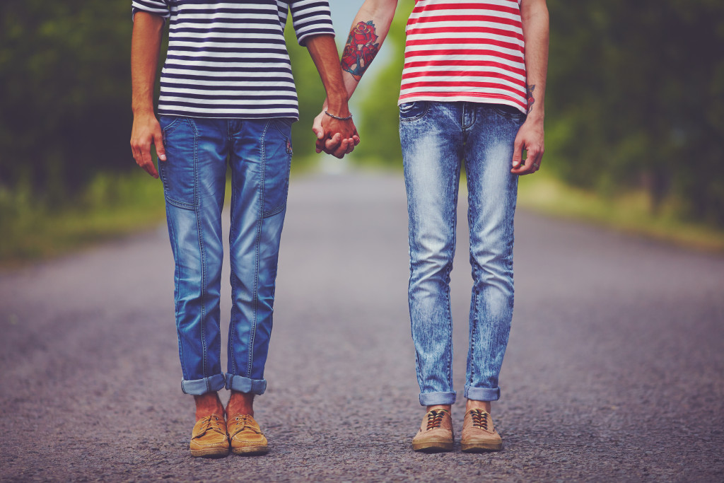 young male couple holding hands